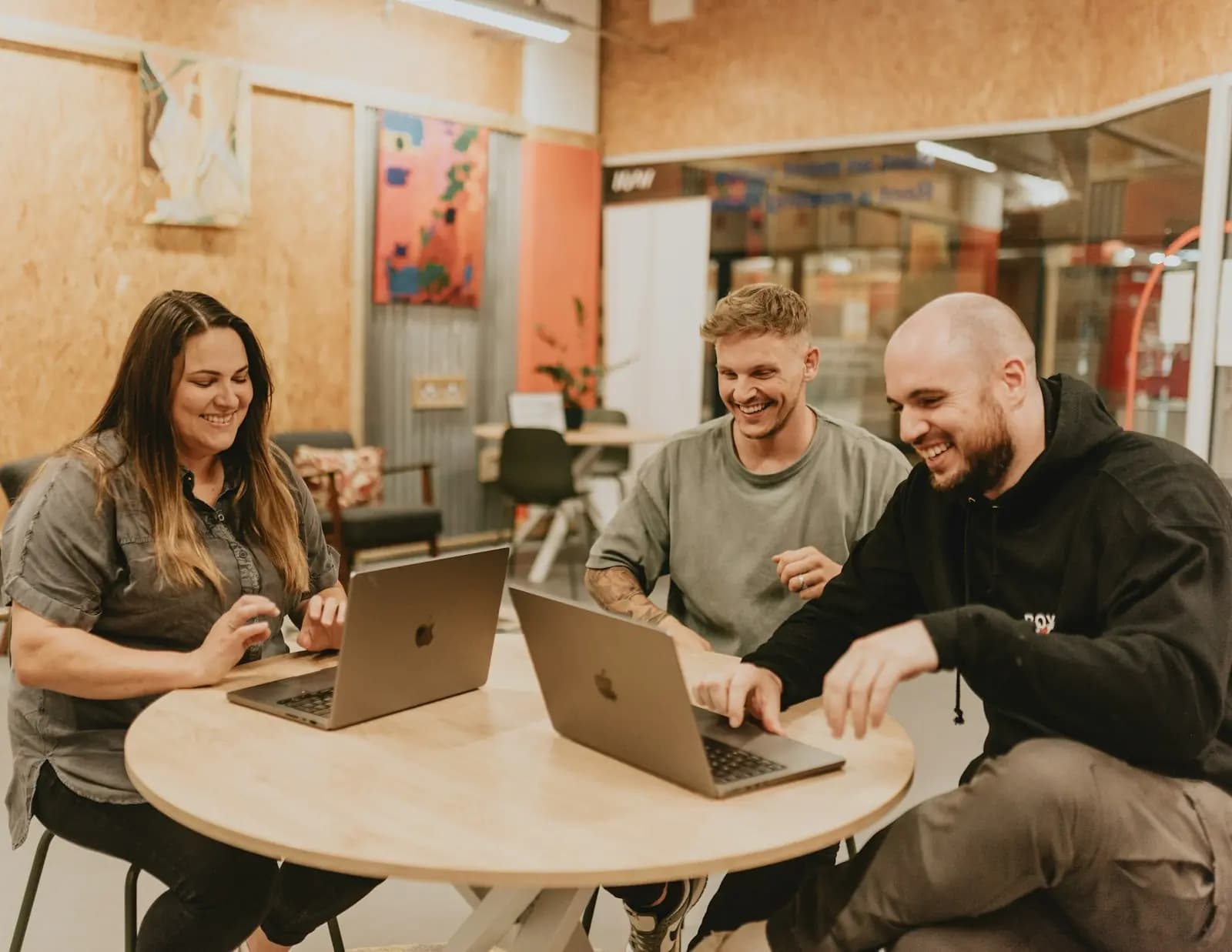 Agency team around a table with laptops