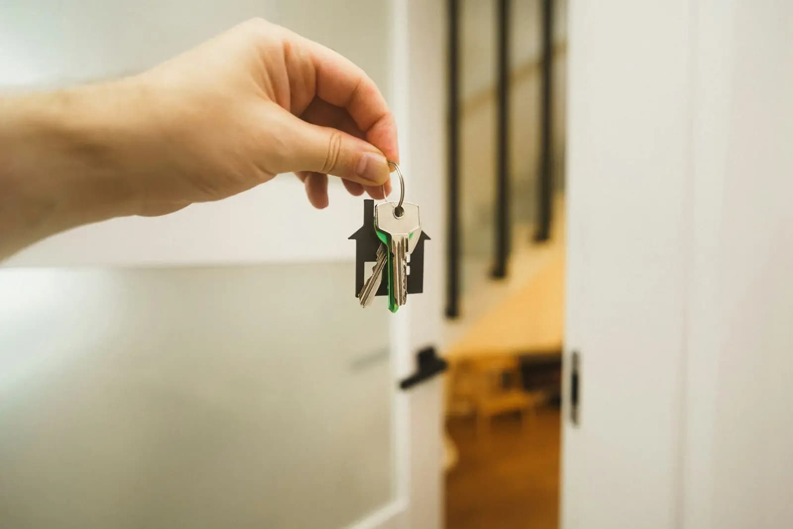 House keys held out at an open door